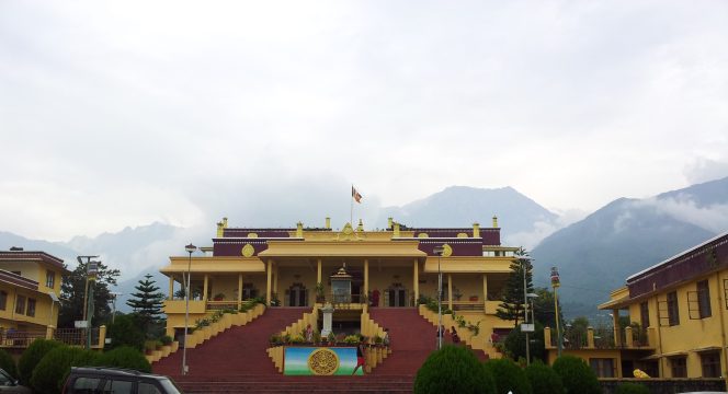 Stark yellow-brown building against majestic mountai