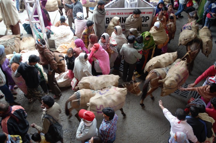 The people queuing up and sitting on the road to visit the cave shrine